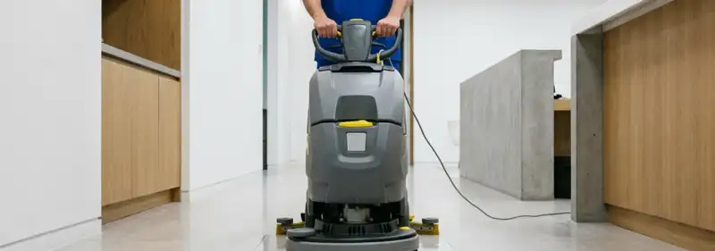 Janitorial staff using a floor scrubber machine to clean a commercial hallway, Savannah, GA.
