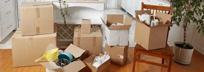 Packed moving boxes and household items in a kitchen before move-out or move-in cleaning, Savannah, GA.